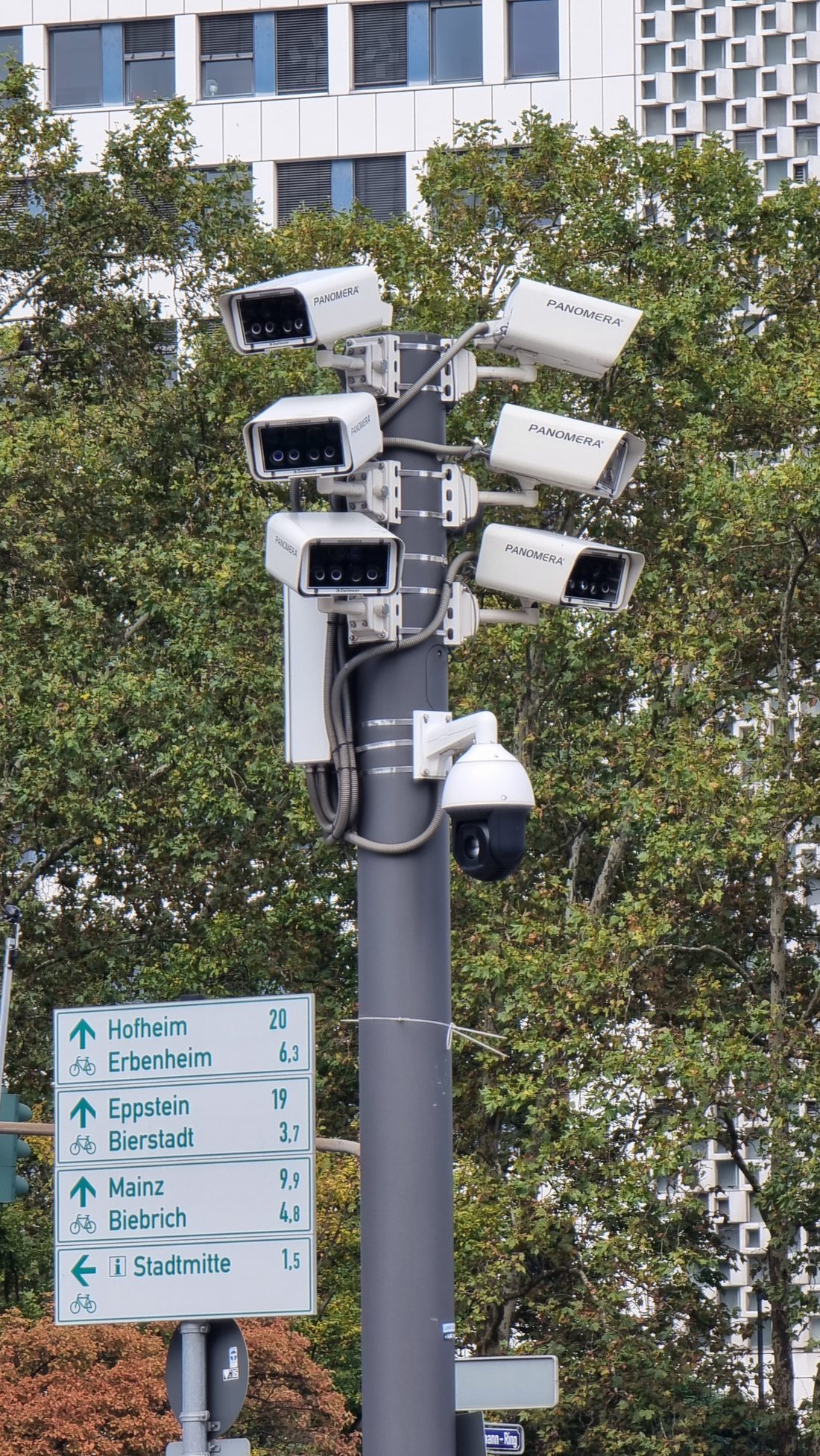 Pole-mounted cluster of CCTV surveillance cameras — integrated camera feature.